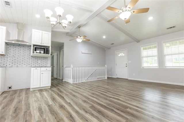 unfurnished living room with visible vents, light wood-style flooring, and ceiling fan with notable chandelier