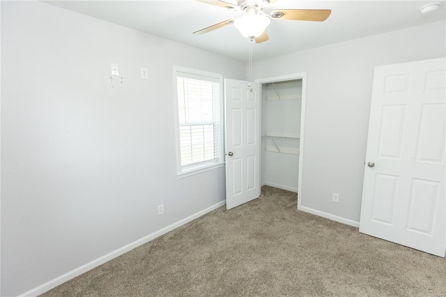 unfurnished bedroom featuring baseboards, ceiling fan, carpet, and a closet