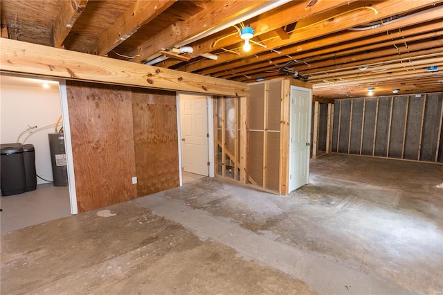 unfinished basement with electric water heater