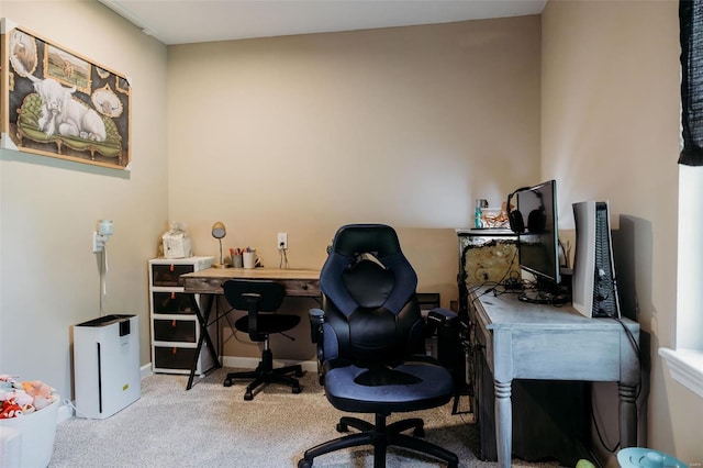 carpeted home office featuring baseboards