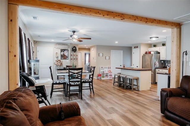 living room featuring visible vents, beam ceiling, ceiling fan, recessed lighting, and light wood finished floors