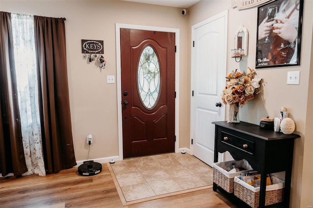 entryway featuring baseboards and light wood-type flooring