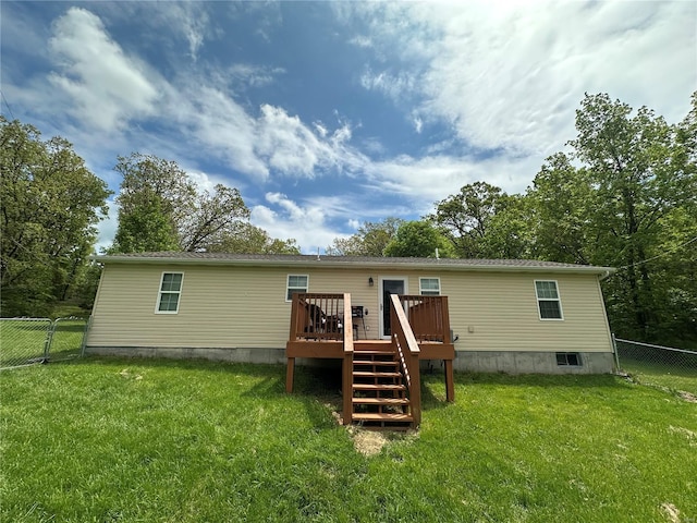 back of house featuring a lawn, a wooden deck, and a fenced backyard