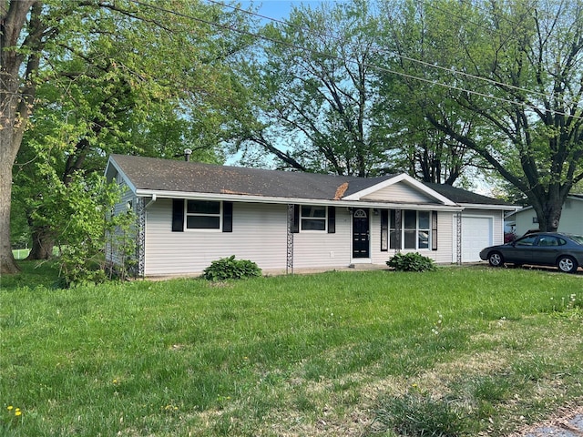 ranch-style house featuring an attached garage and a front lawn