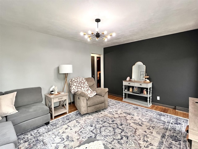 living room with a chandelier, wood finished floors, and baseboards