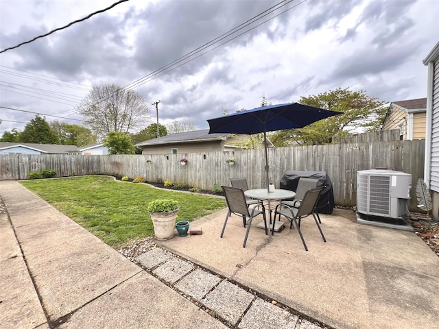 view of patio / terrace with a fenced backyard, outdoor dining area, and central AC