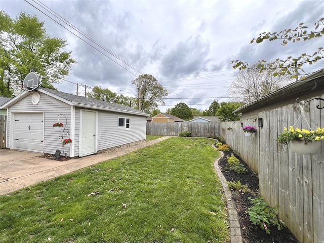 view of yard featuring concrete driveway, an outbuilding, fence private yard, and a detached garage