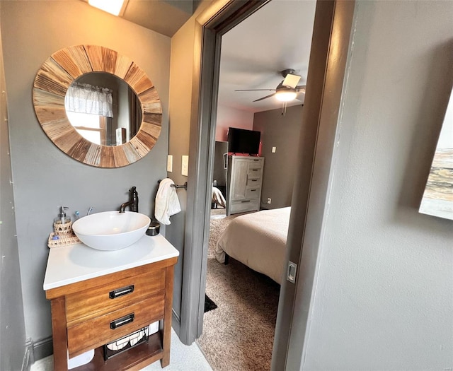 bathroom with connected bathroom, vanity, and ceiling fan
