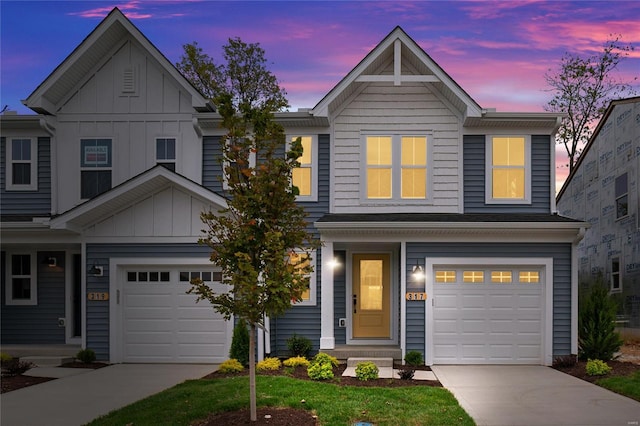 view of front of property featuring board and batten siding, an attached garage, and driveway