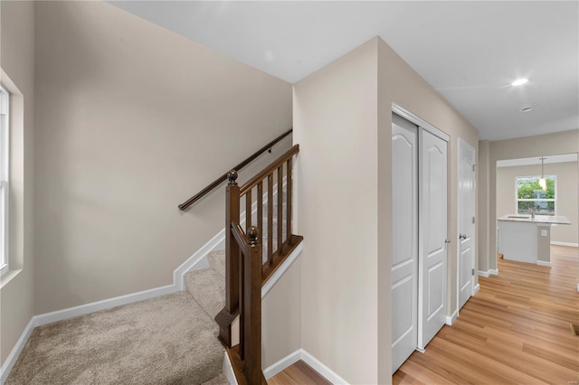 stairs with baseboards and wood finished floors