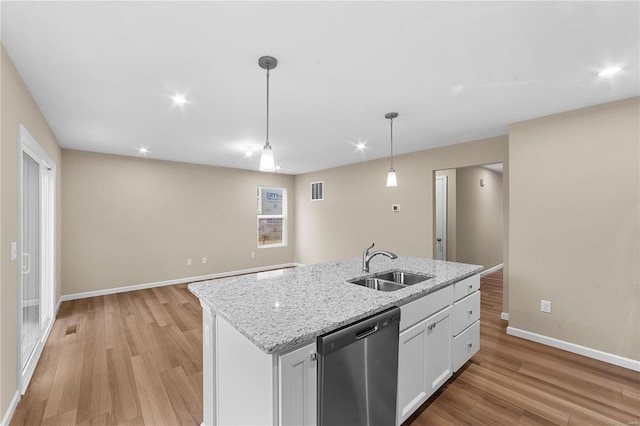 kitchen featuring baseboards, a sink, light wood finished floors, and dishwasher