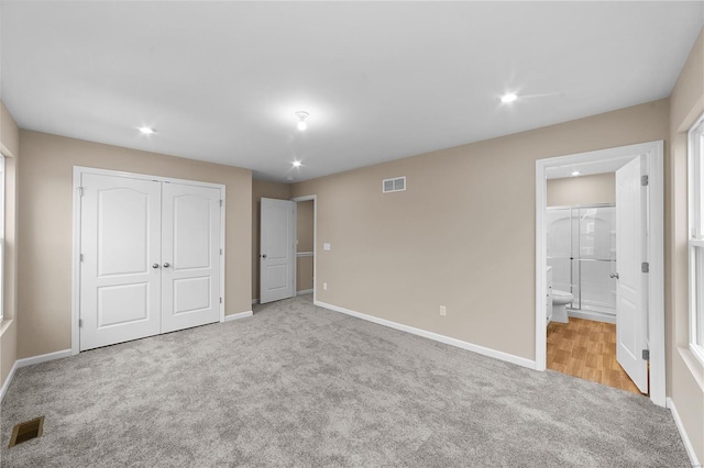 unfurnished bedroom with baseboards, visible vents, and carpet