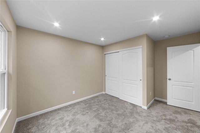 unfurnished bedroom with recessed lighting, carpet flooring, and baseboards