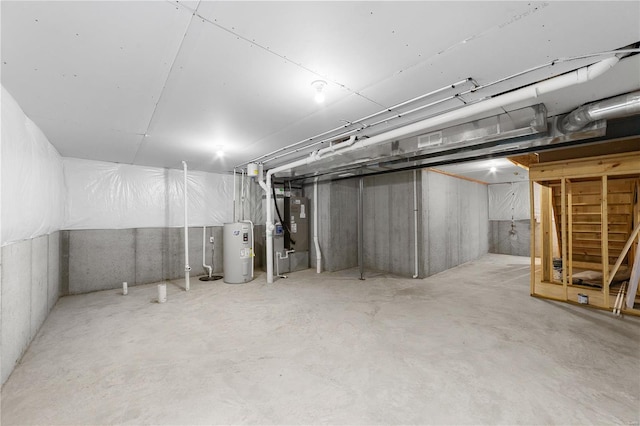 unfinished basement with heating unit, visible vents, and electric water heater