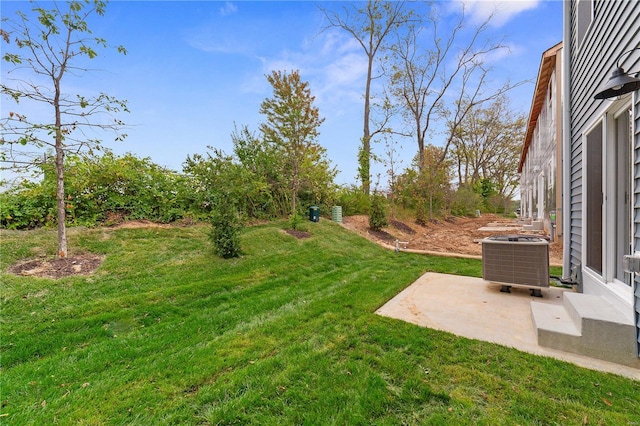 view of yard with central AC unit and a patio area