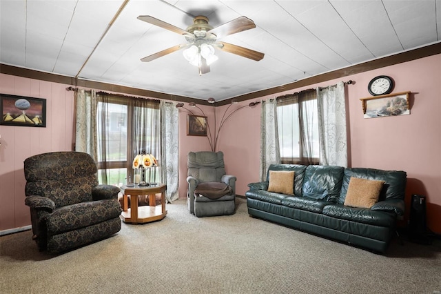 carpeted living area featuring a ceiling fan