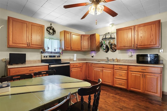 kitchen with black microwave, a sink, brown cabinetry, electric stove, and a ceiling fan