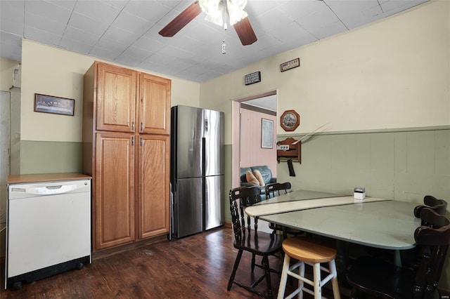 kitchen featuring ceiling fan, white dishwasher, brown cabinets, freestanding refrigerator, and dark wood-style floors