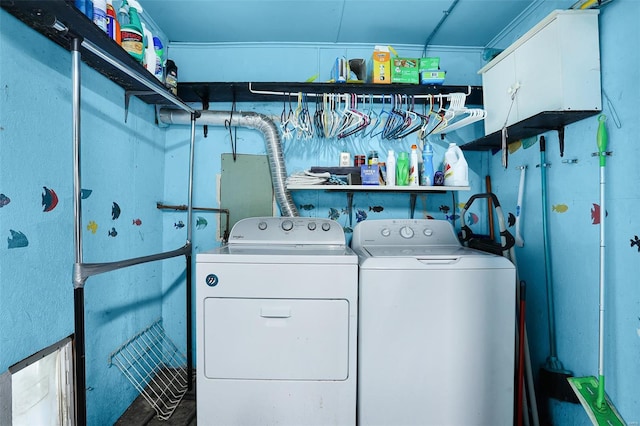 laundry area with separate washer and dryer and cabinet space