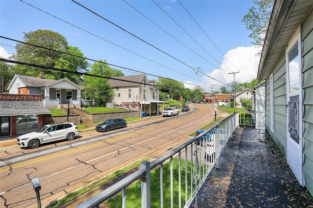 view of road featuring a residential view, sidewalks, and curbs