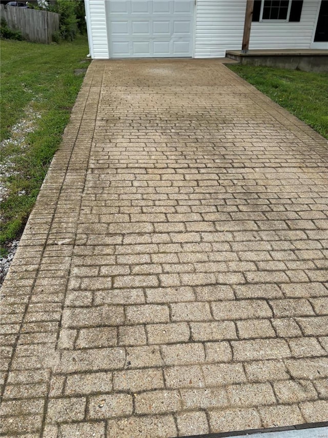 details with fence and decorative driveway