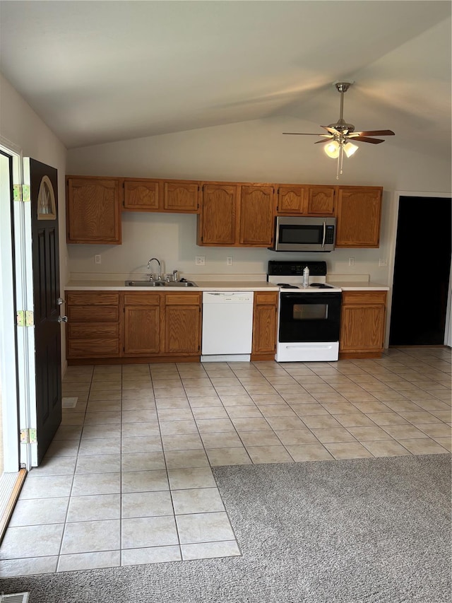 kitchen featuring a sink, dishwasher, electric stove, stainless steel microwave, and lofted ceiling