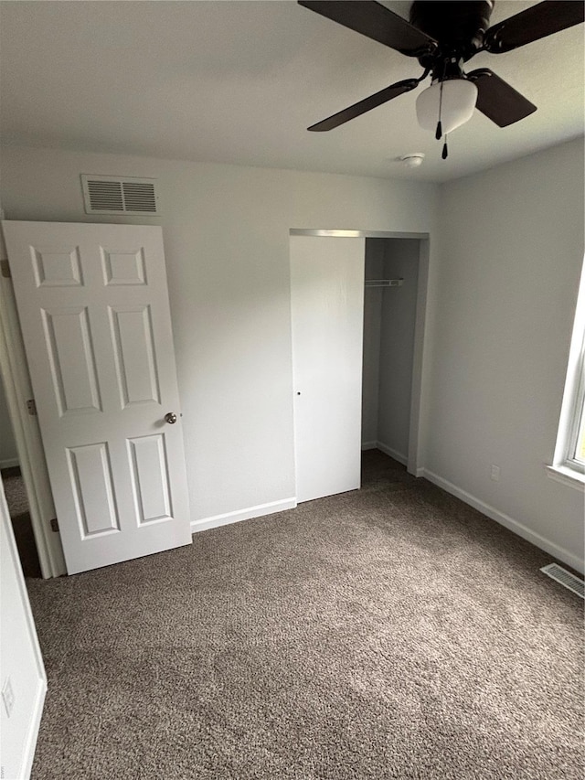 unfurnished bedroom featuring visible vents, a ceiling fan, carpet, and a closet