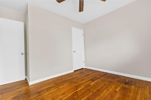 spare room featuring baseboards, a ceiling fan, and hardwood / wood-style floors