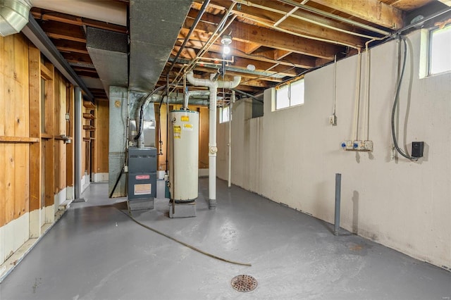 basement featuring water heater and heating unit