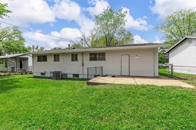 back of property featuring a yard, a patio, fence, and central AC unit