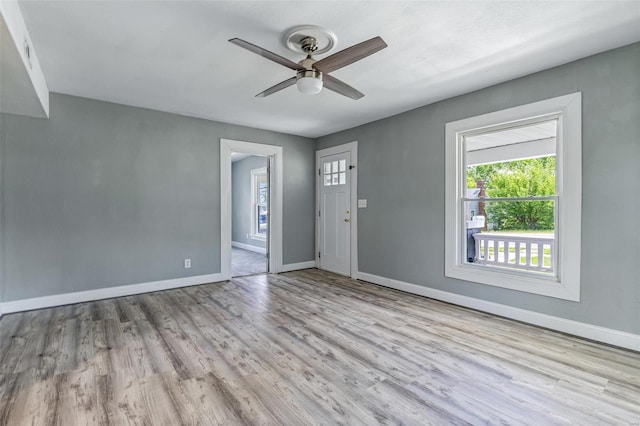 interior space featuring baseboards, ceiling fan, and wood finished floors