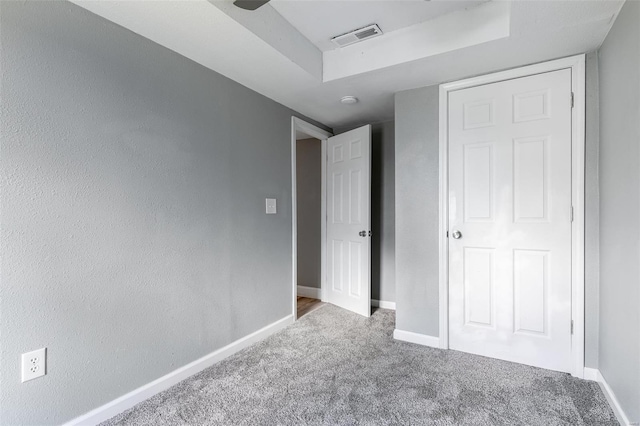 unfurnished bedroom with carpet flooring, baseboards, and visible vents