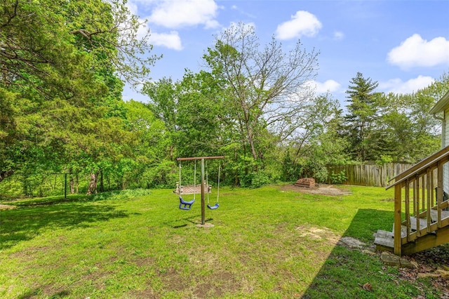 view of yard featuring a playground and fence