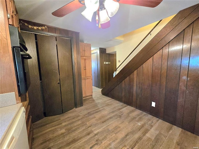 interior space with ceiling fan, stairs, and wood finished floors