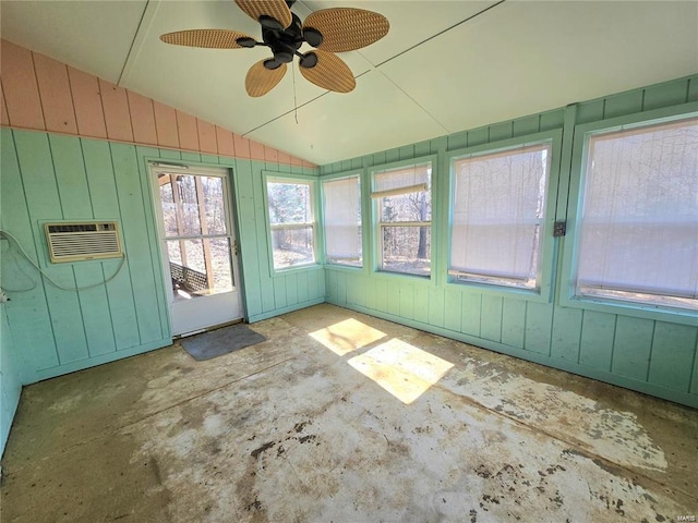 unfurnished sunroom with an AC wall unit, ceiling fan, and lofted ceiling