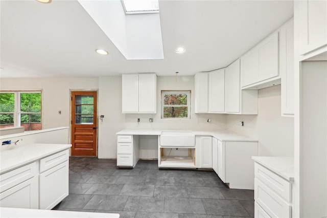 kitchen with light countertops, white cabinetry, and recessed lighting