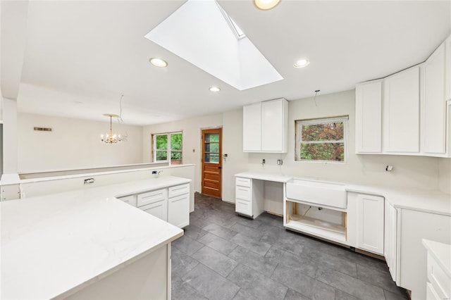 kitchen with recessed lighting, visible vents, light countertops, white cabinets, and a skylight