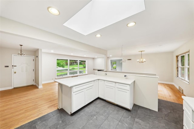 kitchen with visible vents, recessed lighting, an inviting chandelier, light countertops, and white cabinets