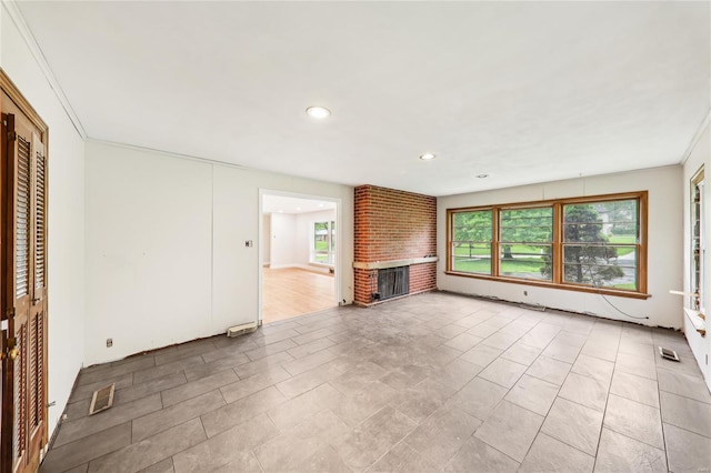 unfurnished living room featuring a fireplace, visible vents, and recessed lighting