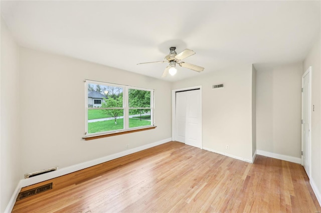 unfurnished bedroom with a closet, visible vents, light wood-style flooring, and baseboards