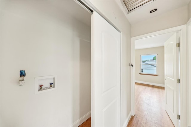 corridor with light wood finished floors and baseboards