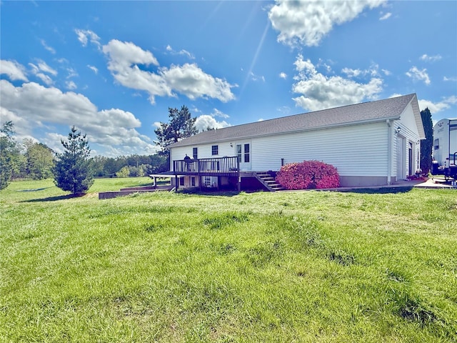 back of property with a lawn and a deck