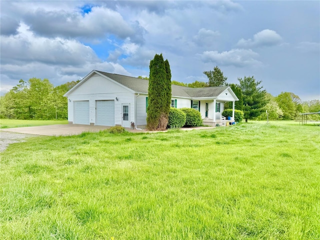view of front of property featuring driveway, a front lawn, and a garage