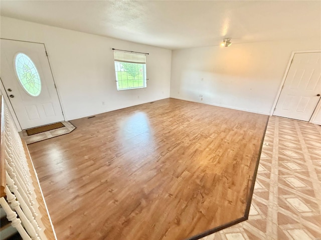 foyer entrance with light wood-style flooring