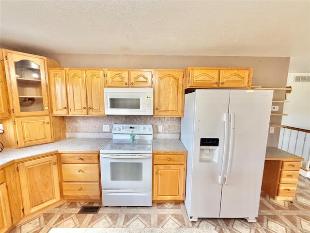 kitchen featuring light countertops, glass insert cabinets, white appliances, and visible vents
