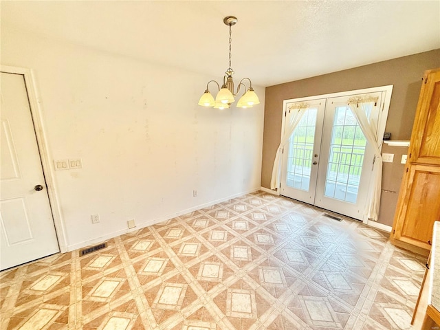 unfurnished room with baseboards, an inviting chandelier, french doors, and visible vents