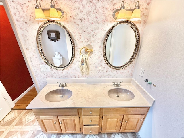 full bathroom featuring wallpapered walls and a sink