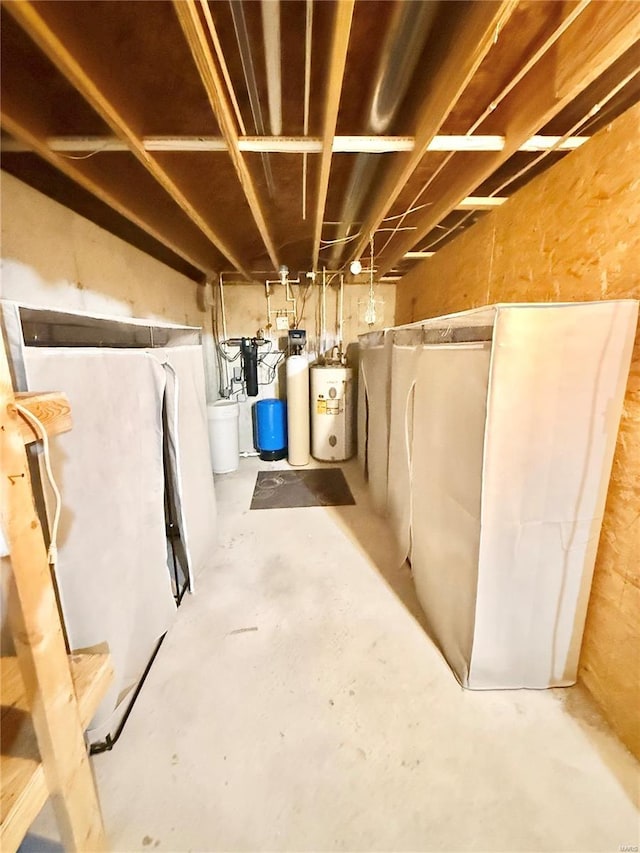 unfinished basement featuring electric water heater