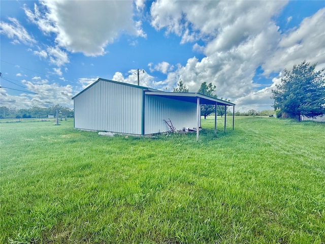 view of pole building featuring a lawn and a carport
