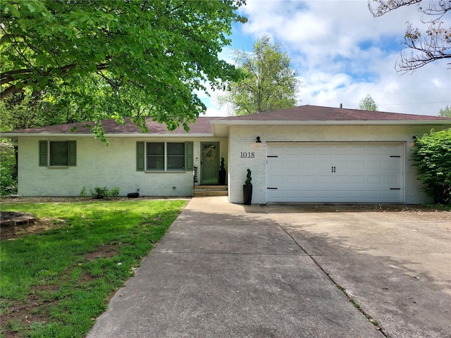 ranch-style house with brick siding, a garage, a front lawn, and driveway